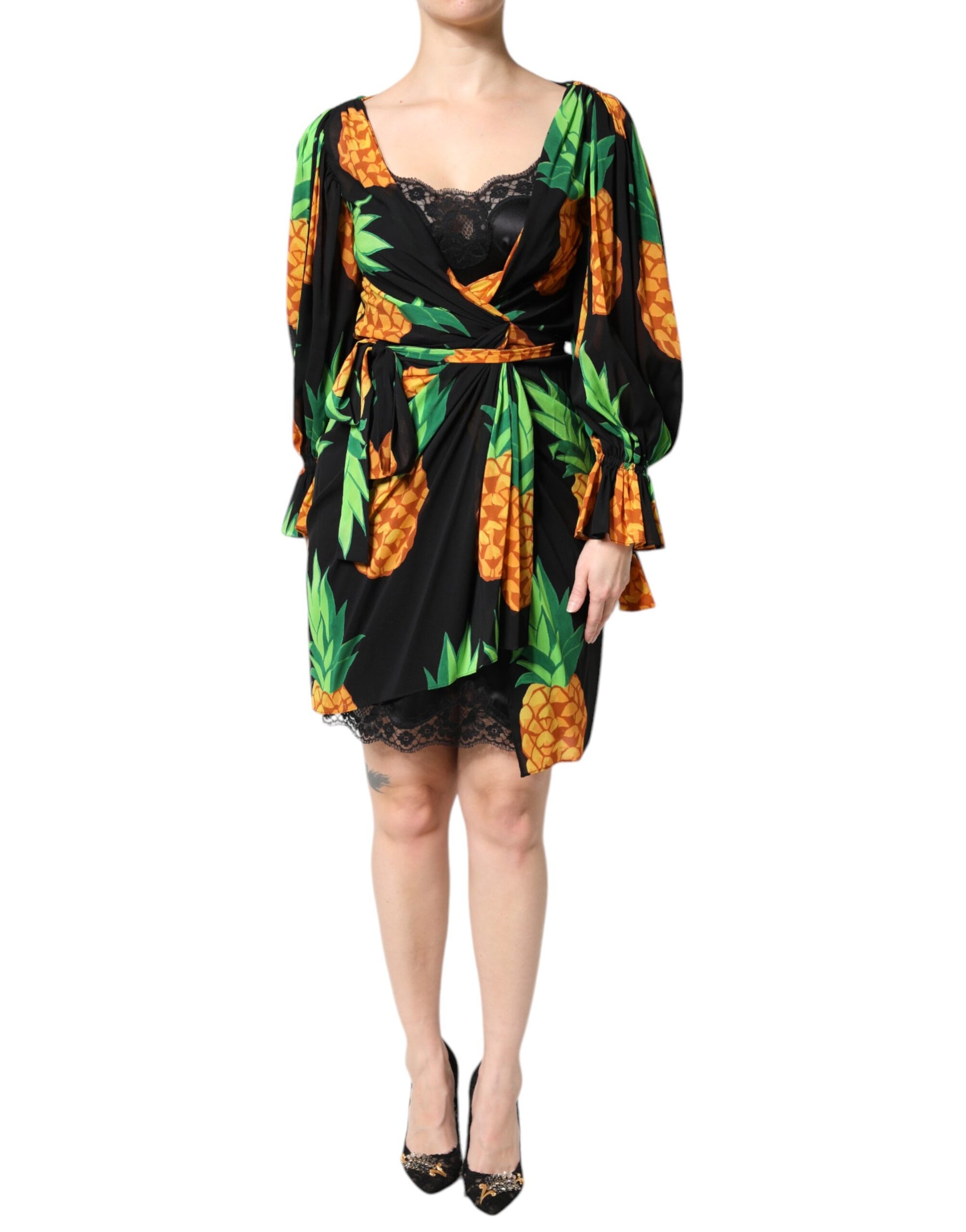 A black silk dress with a pineapple print and draped design