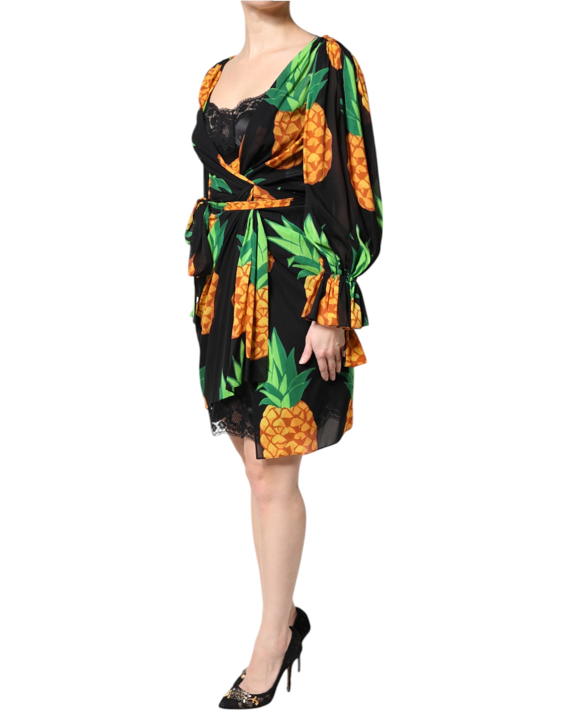 A black silk dress with a pineapple print and draped design