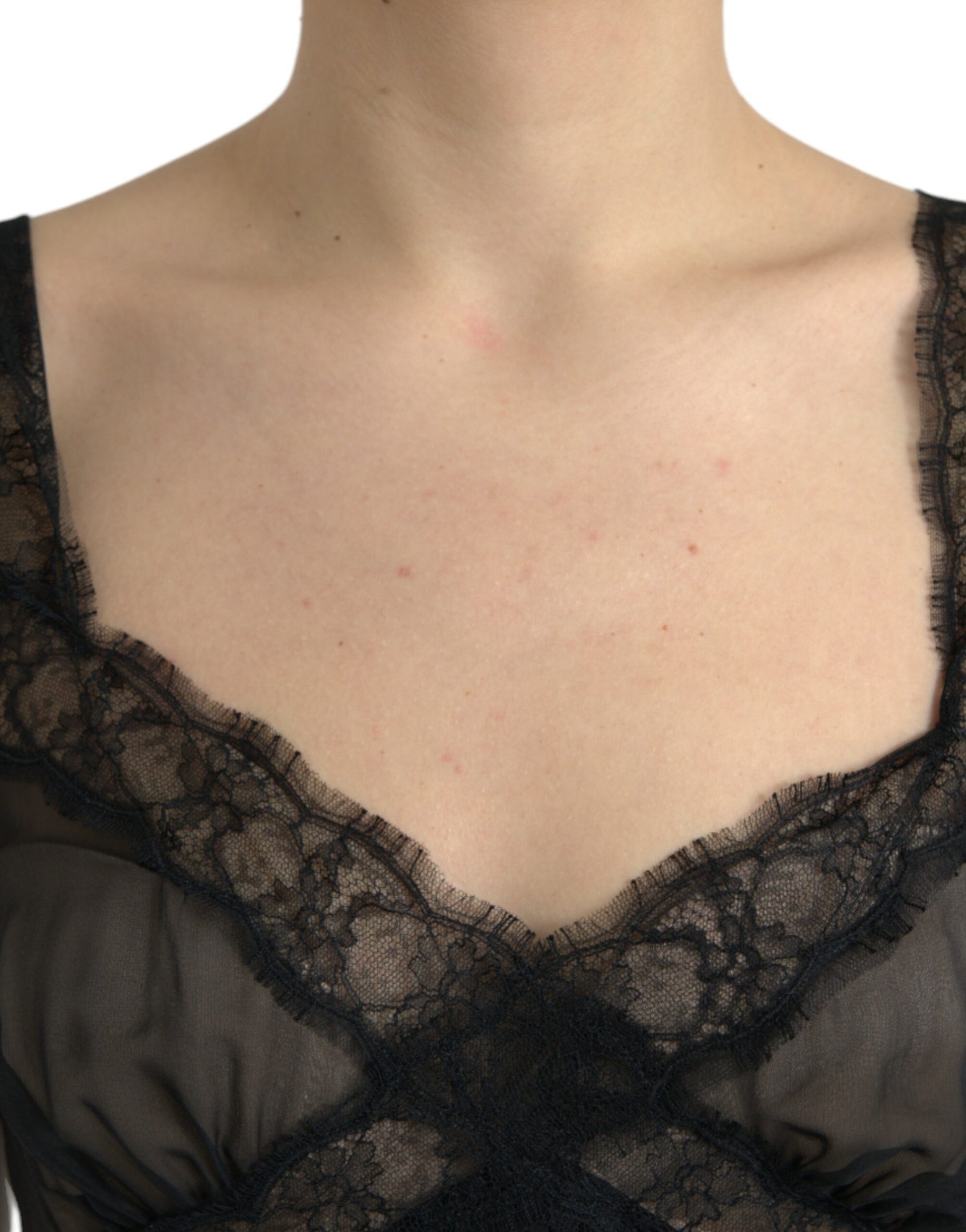 A black silk pleated lace chiffon mini dress with a sheer neckline