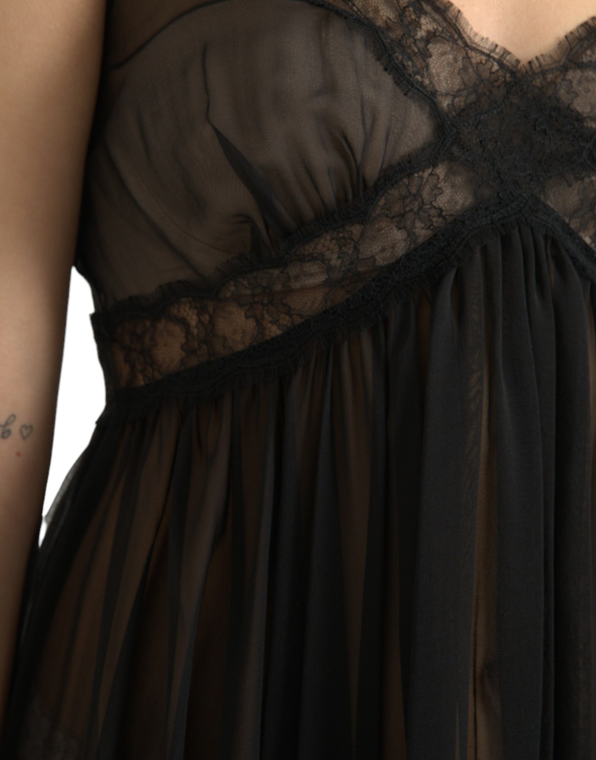 A black silk pleated lace chiffon mini dress with a sheer overlay