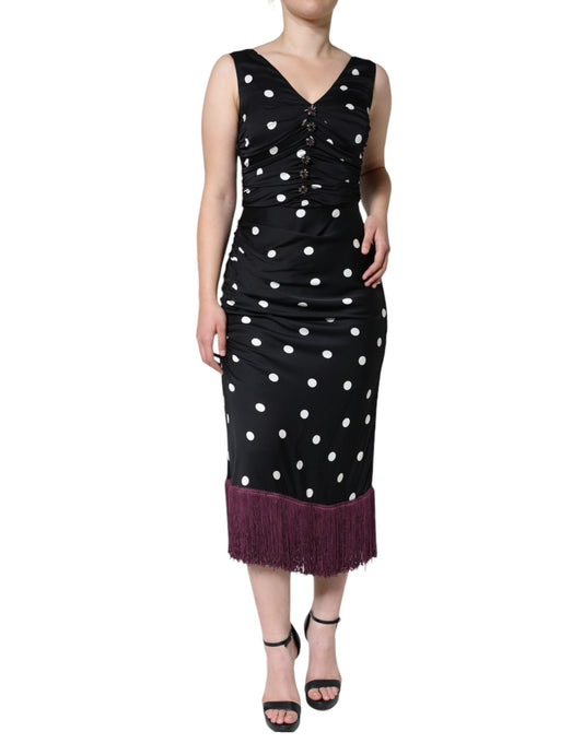 A black silk dress with polka dots and tassels on the hem