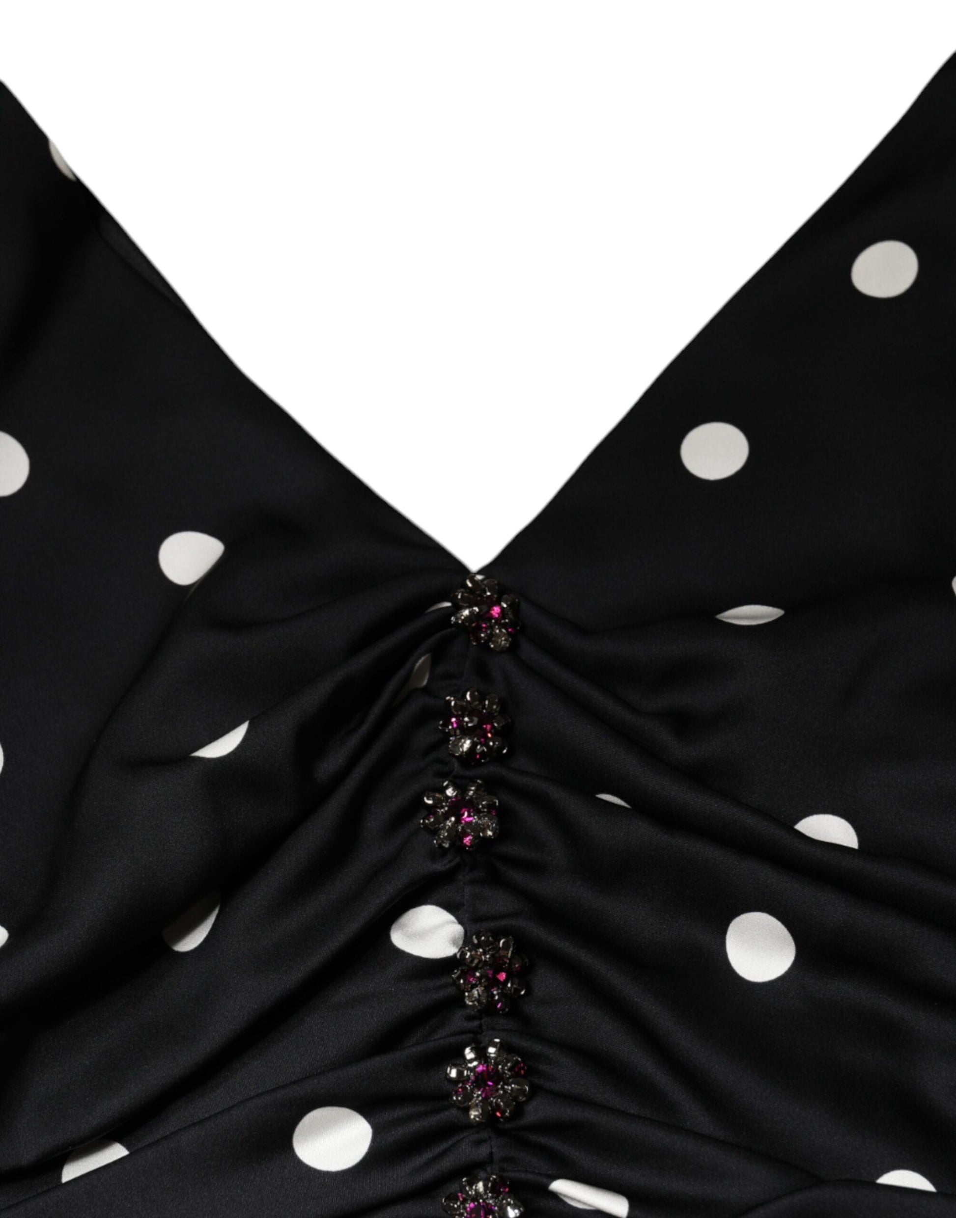 A black silk dress with polka dots and tassels on the neckline