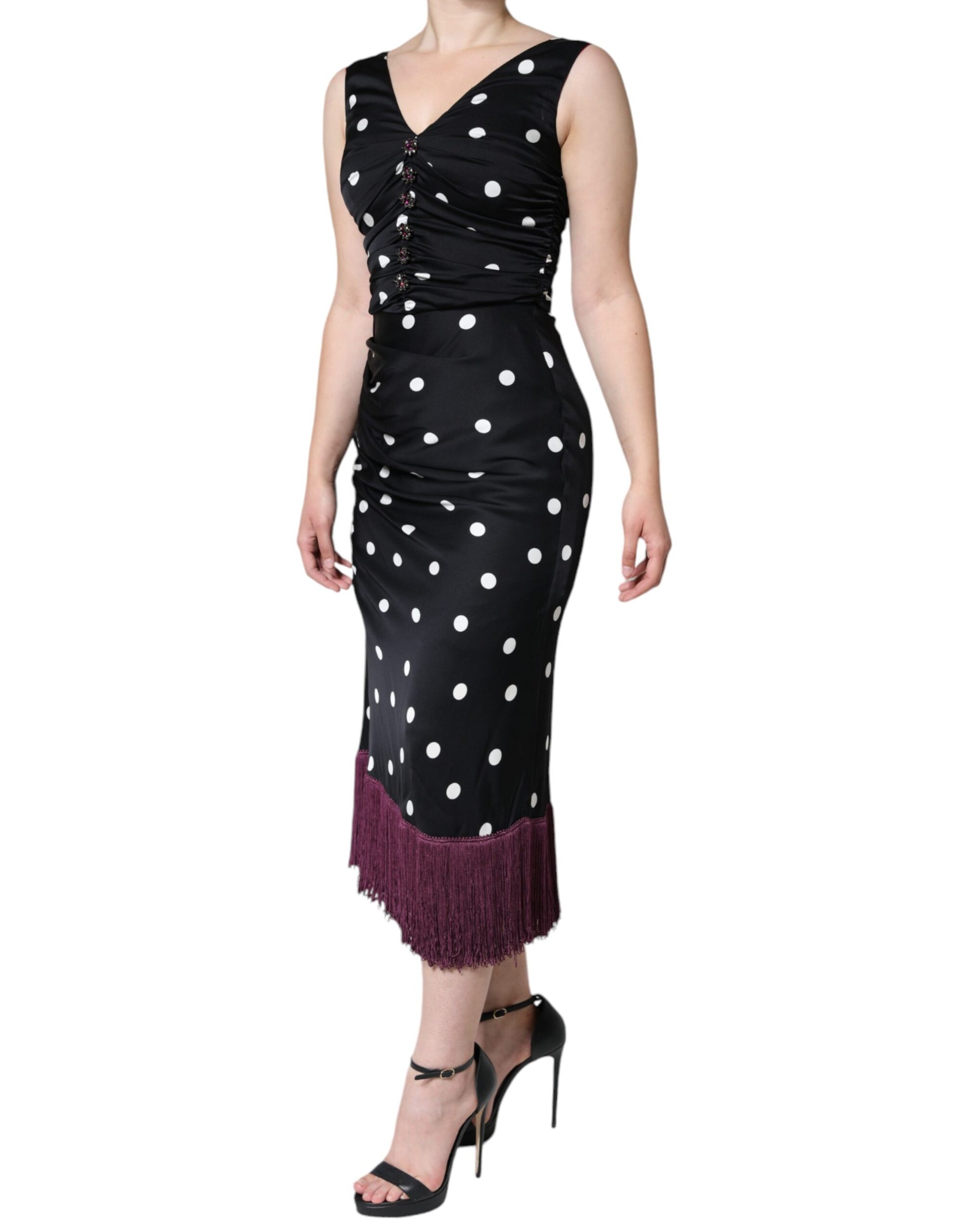 A black silk midi dress with polka dots and tassels