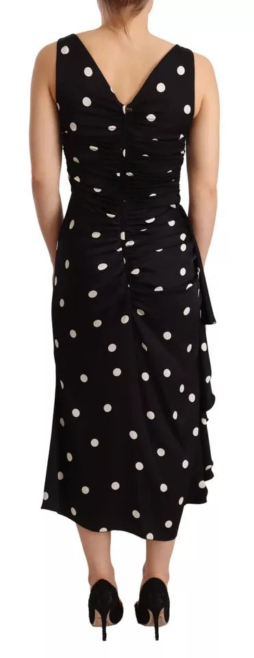 A black silk midi dress with polka dots and a V-neck