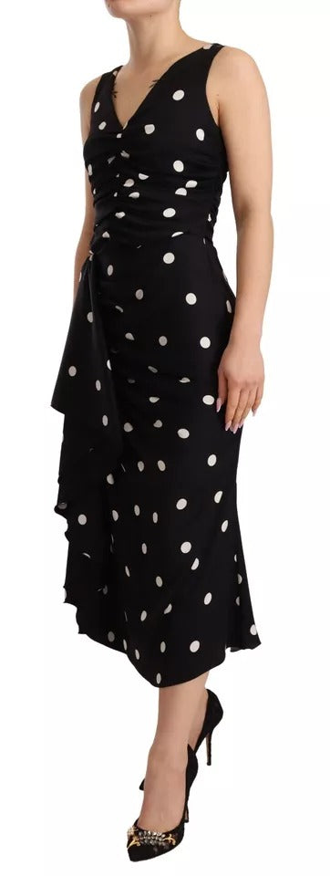 A black silk midi dress with polka dots and a V-neck