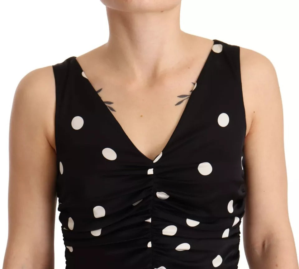 A black silk polka dot dress with a V-neck and midi length