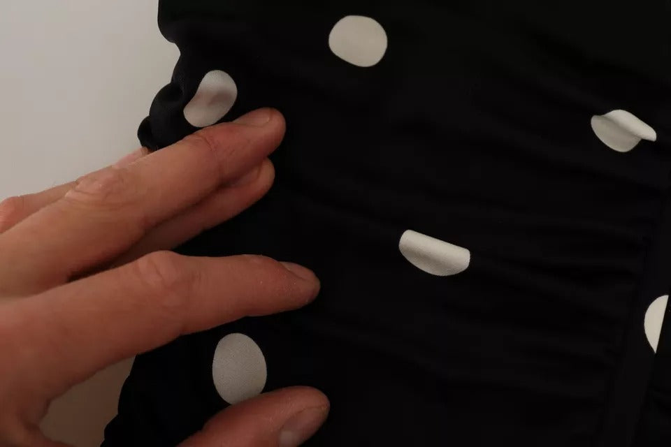 A black silk dress with polka dots on the front