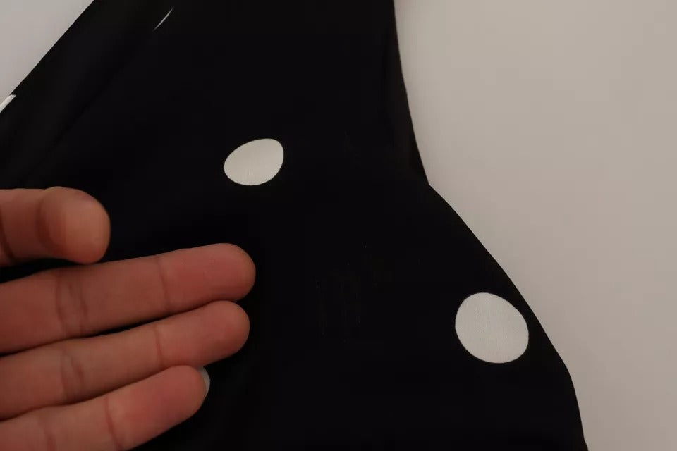 A black silk dress with polka dots and a V-neck