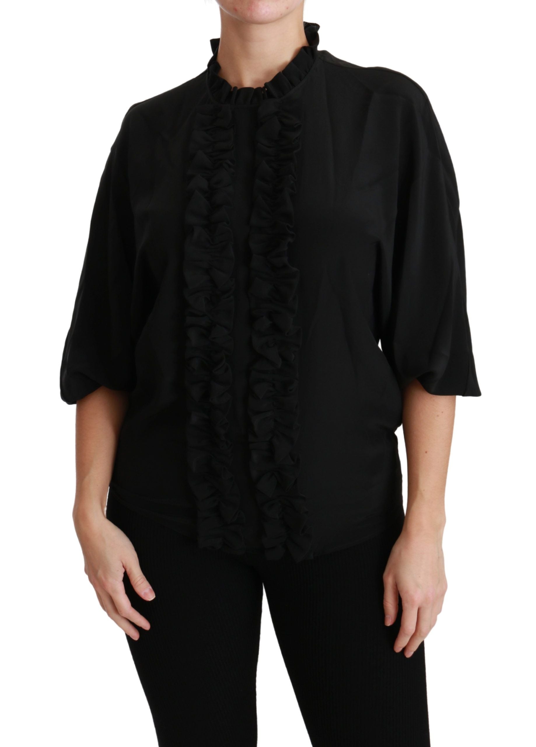 Woman wearing black shirt with ruffles on sleeves