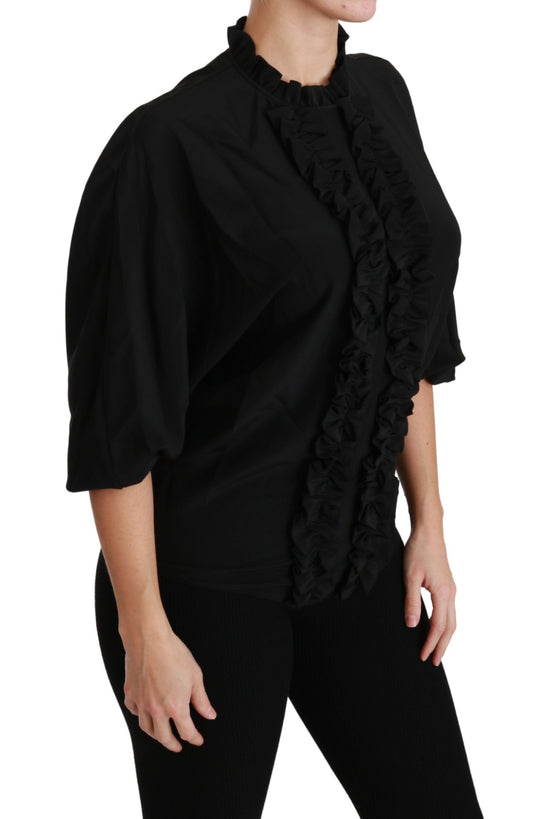 Black ruffled blouse on woman