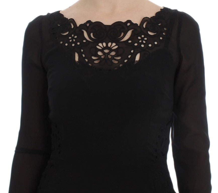 A black silk stretch sheath dress with lace detailing on the bodice