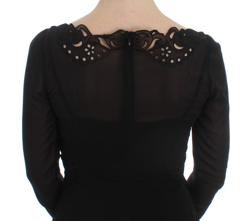 A black silk stretch sheath dress with lace detailing on back and sleeves