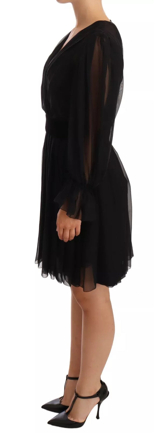 A black silk tulle dress with long sleeves and a V-neck
