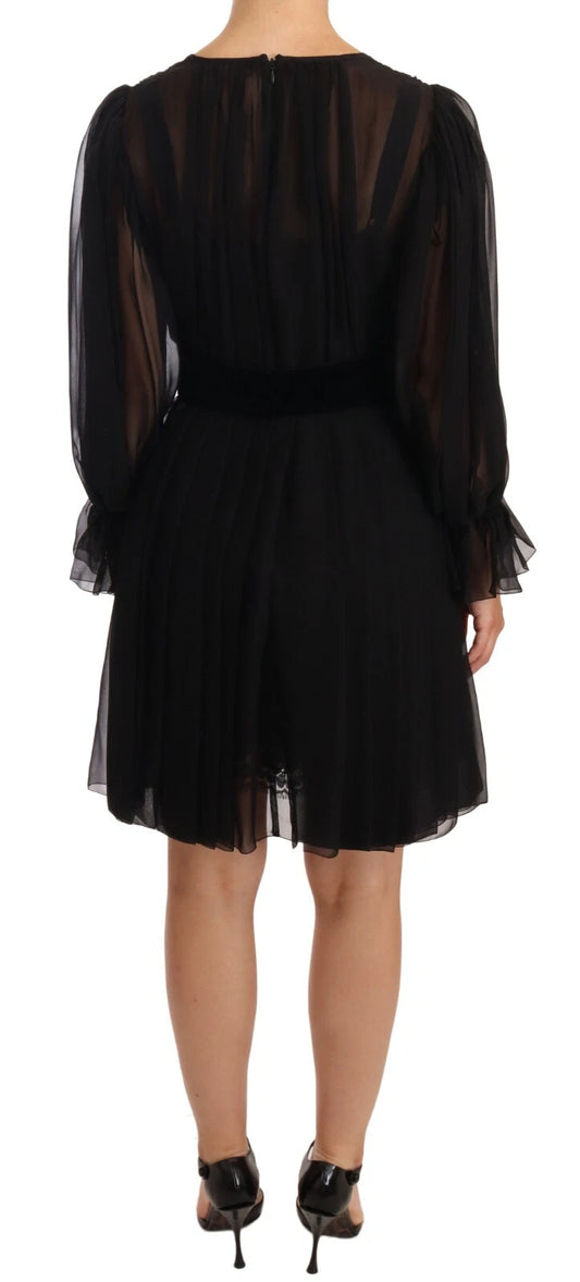 A black silk tulle long sleeve dress with a V-neck