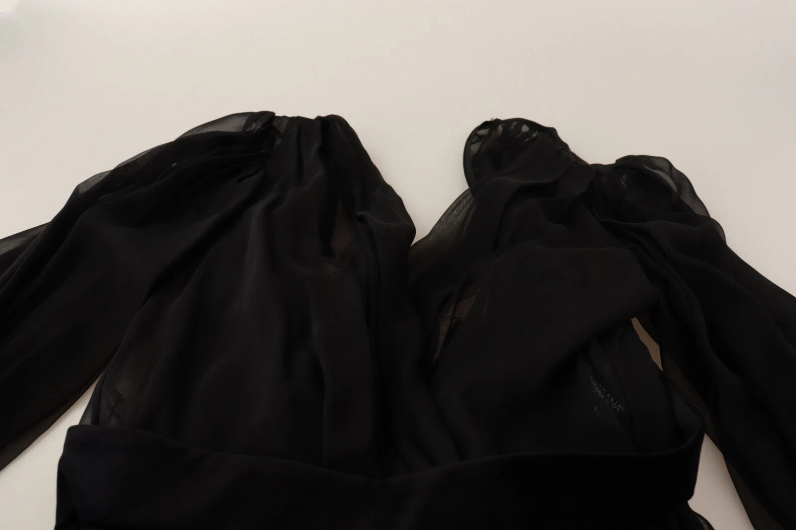 A black silk tulle long sleeve dress with a V-neck