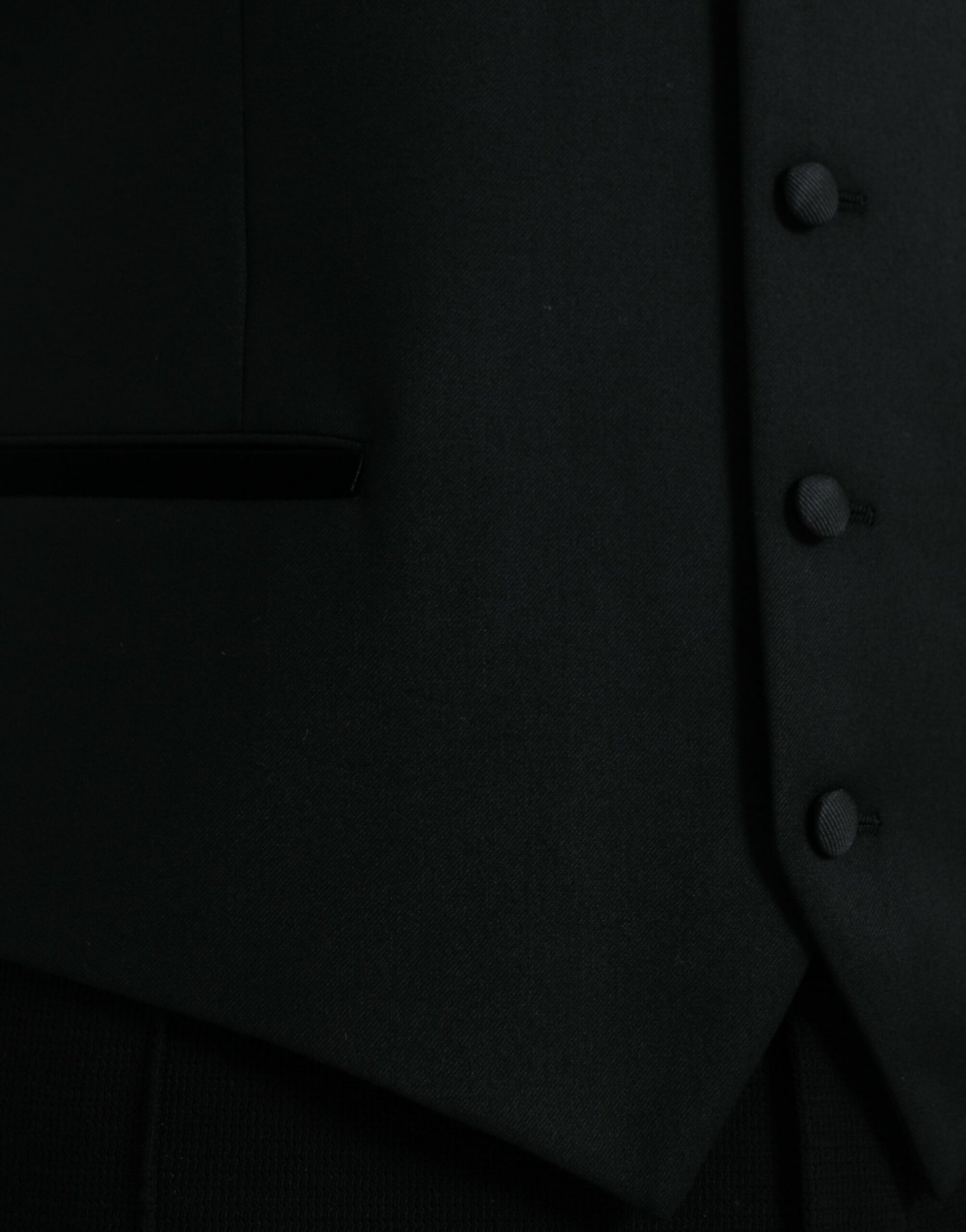 A black silk waistcoat with buttons, part of a formal dress suit