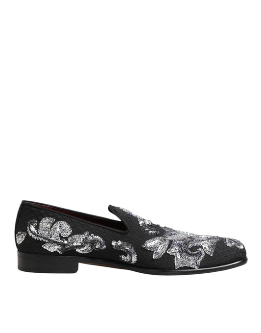 A pair of black sequined loafers with silver floral embroidery, designed for men's dress shoes