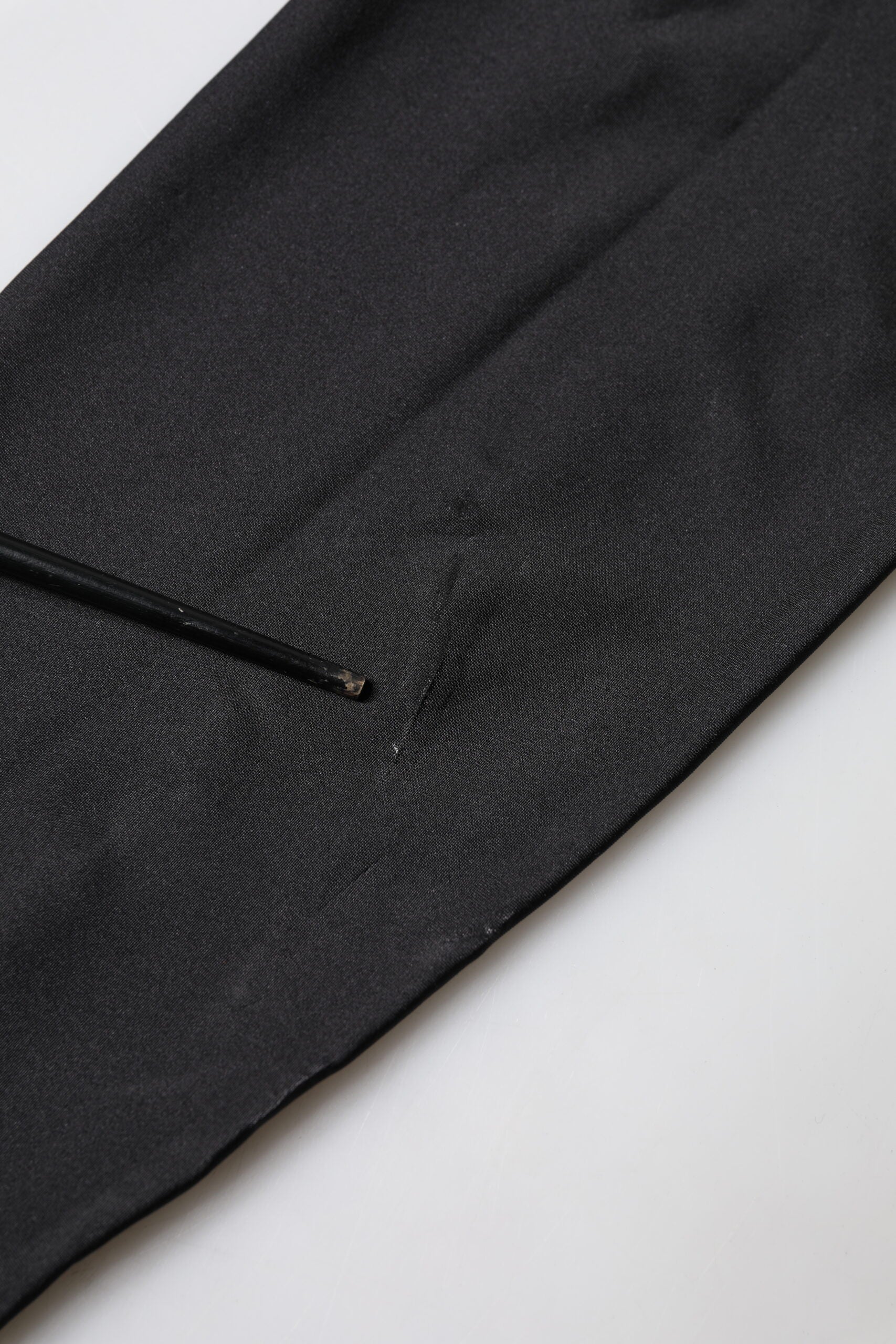 A black sleeveless bodycon jumpsuit dress with a zipper on the front