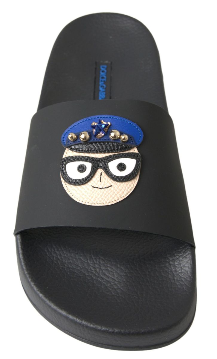 Black slide sandal with embroidered cartoon character on strap