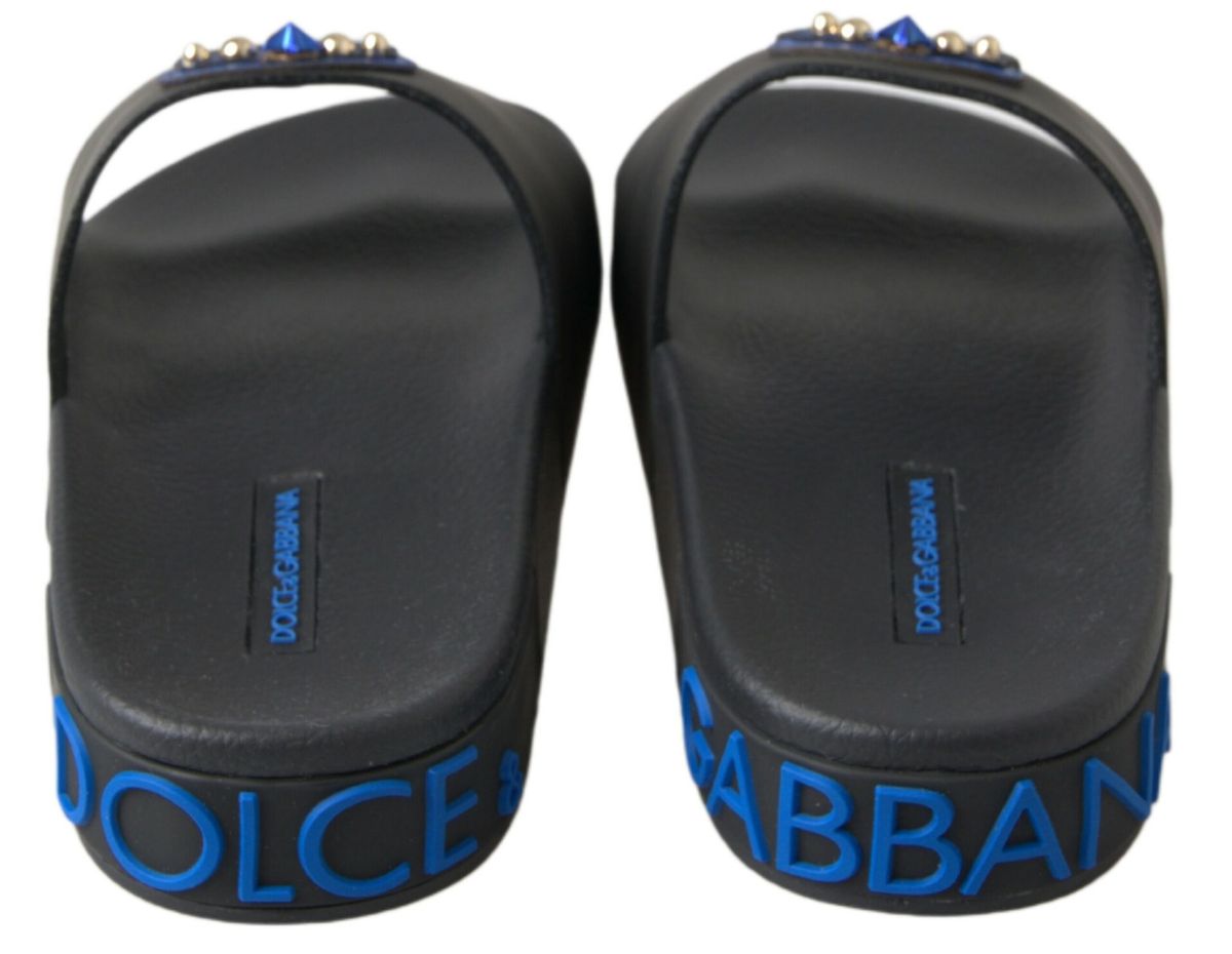 Pair of black flip flops with blue branding