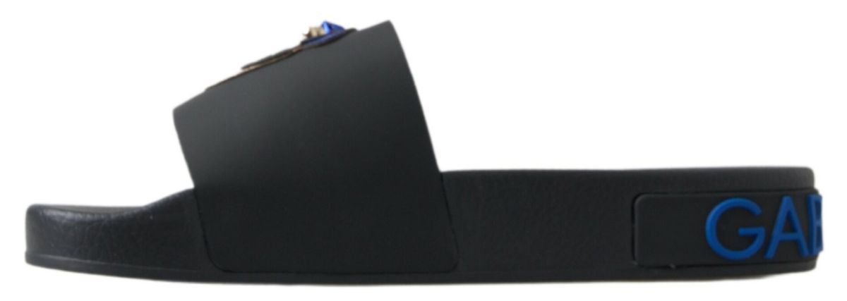 Pair of black sandals with blue lettering on straps