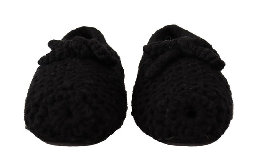 Pair of black baby booties with ties