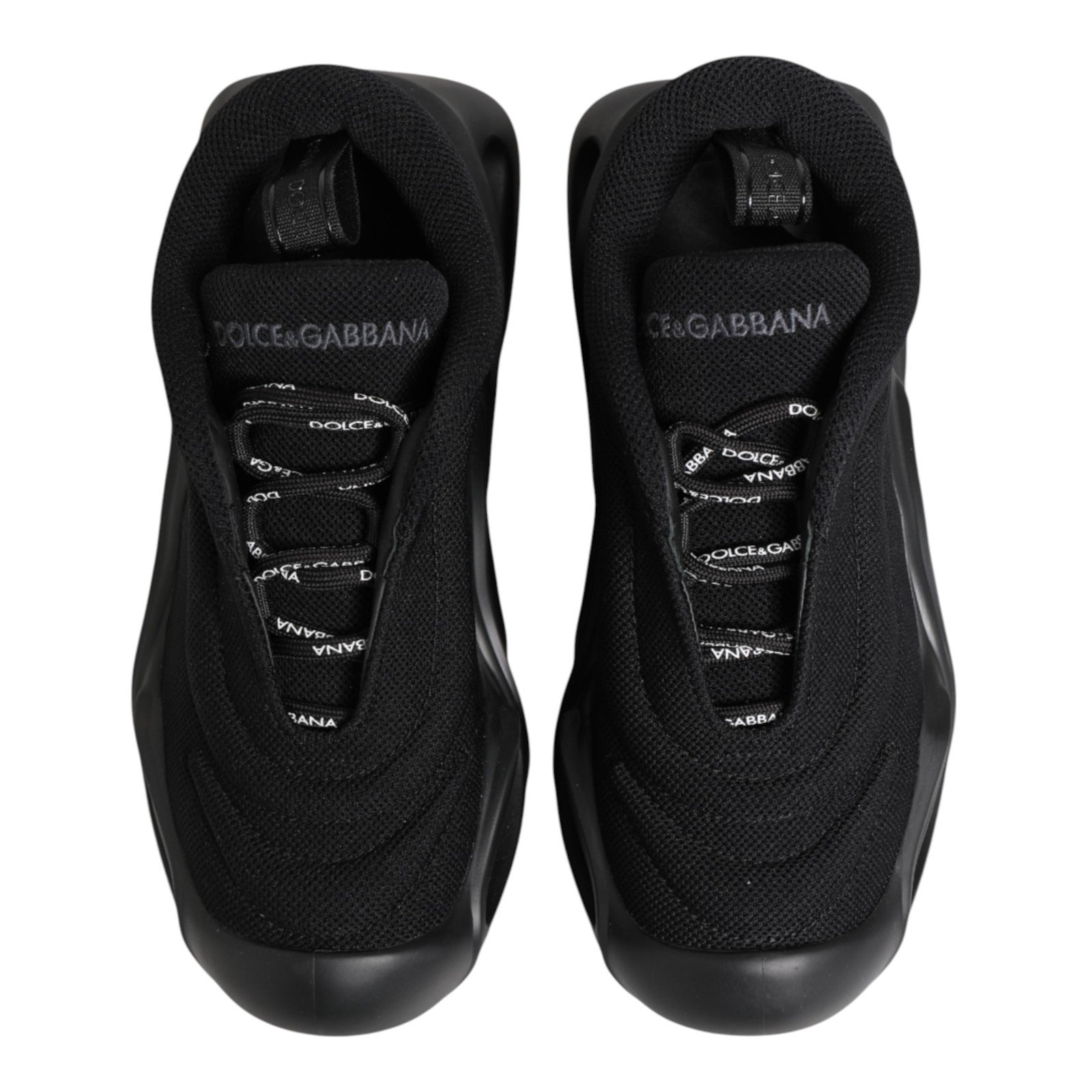 Pair of black slip-on shoes with white logo and laces