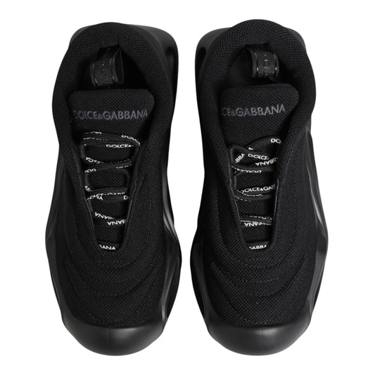 Pair of black slip-on shoes with white logo and laces
