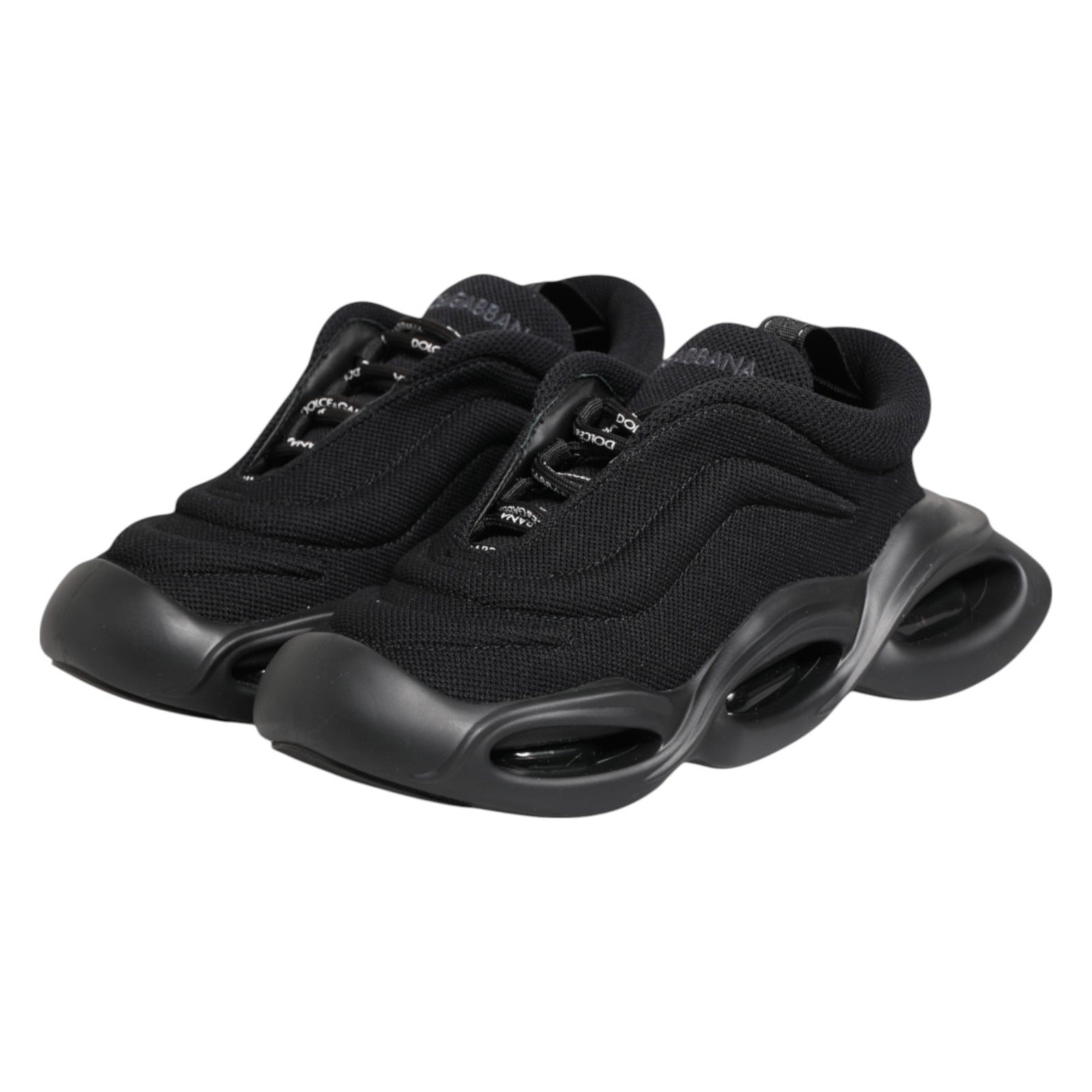 Pair of black slip-on shoes with low top and wave design on soles