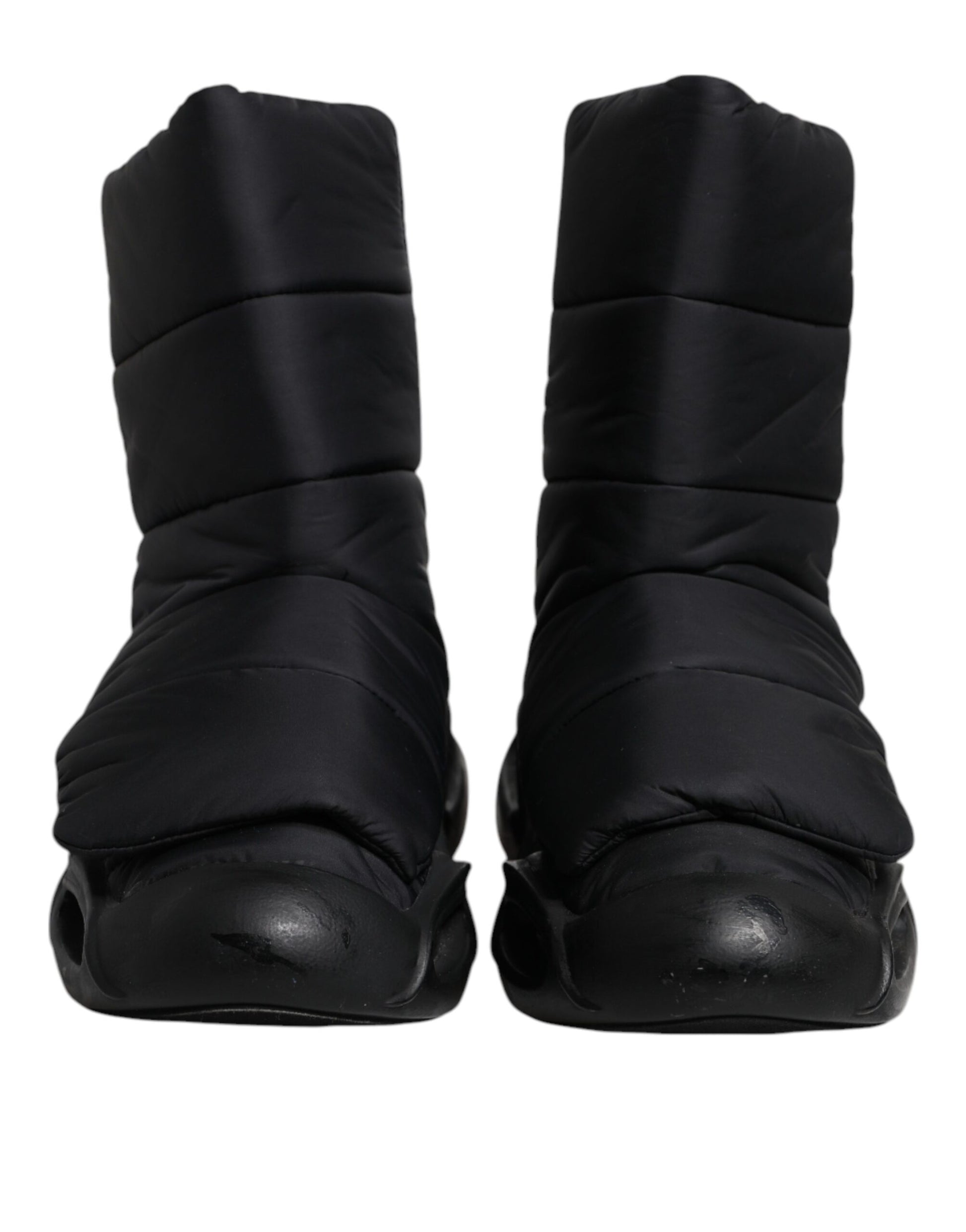 Pair of black slip-on shoes with quilted design and wave pattern