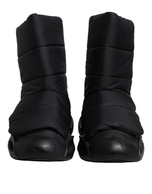 Pair of black slip-on shoes with quilted design and wave pattern