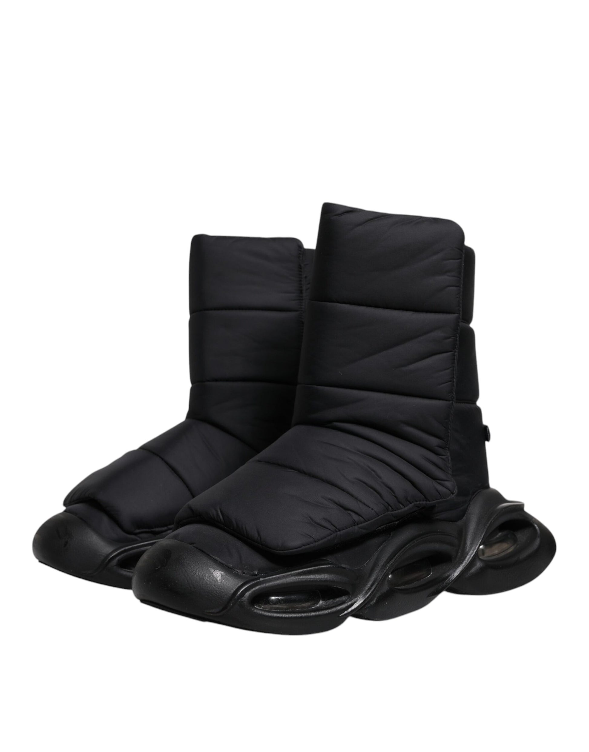 Pair of black slip-on shoes with quilted design and wave pattern