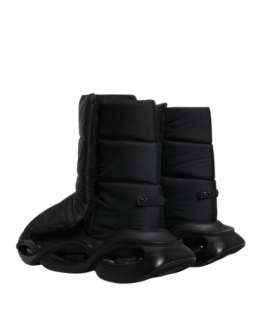 A pair of black slip-on shoes with quilted design and wave pattern