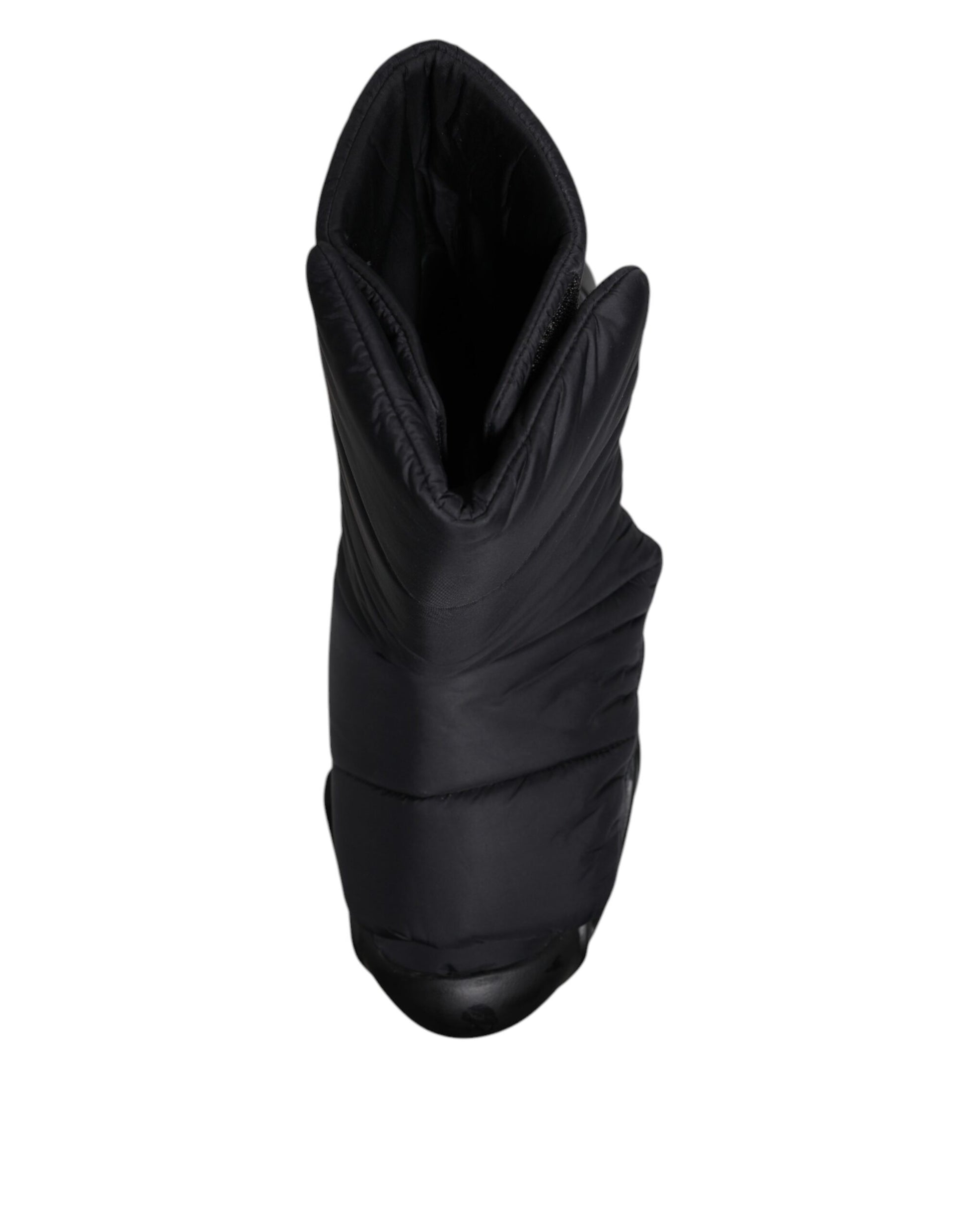 A pair of black quilted slip-on shoes with a wave pattern
