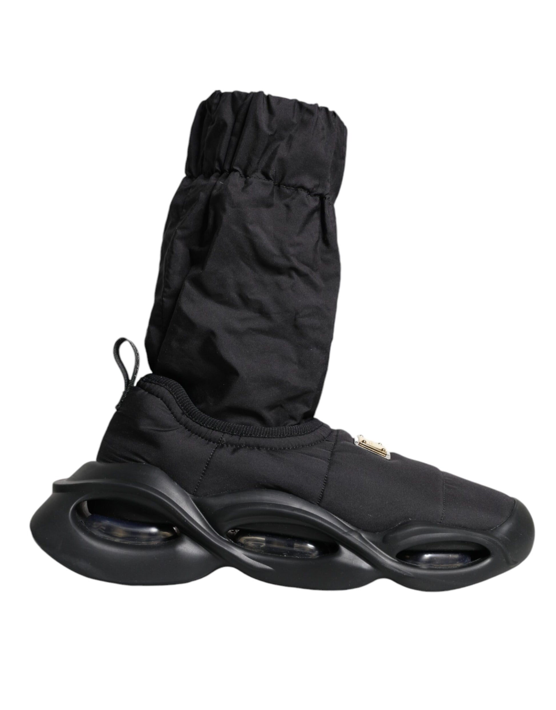 Pair of black roller shoes with white wheels and a black pouch