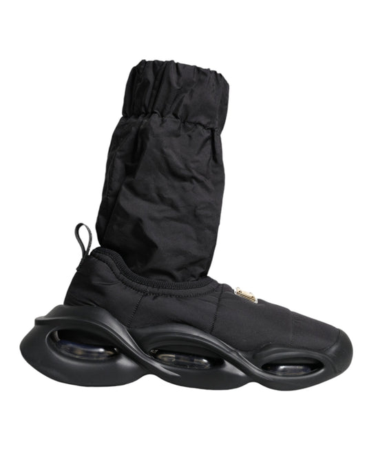 Pair of black roller shoes with white wheels and a black pouch