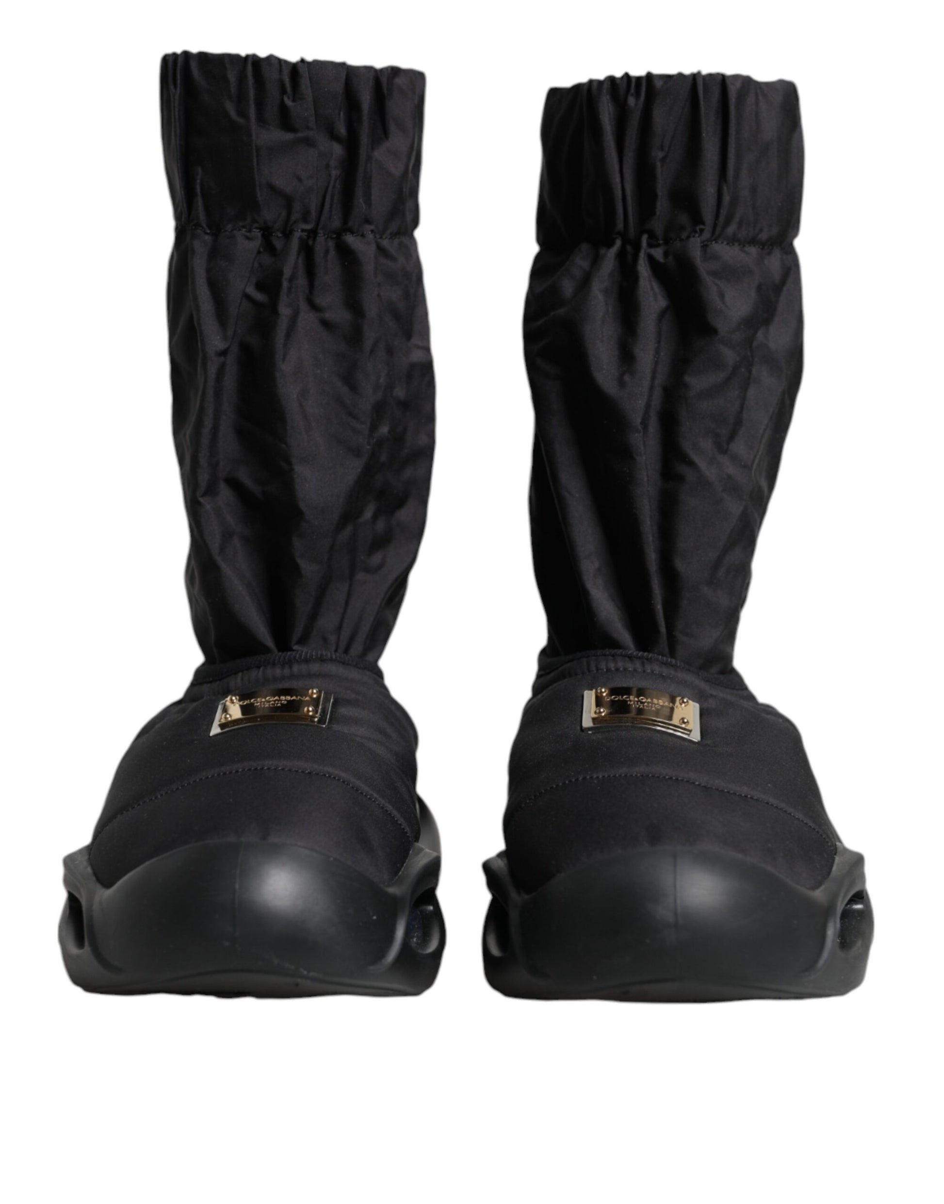 Pair of black boots with gold buckles and straps