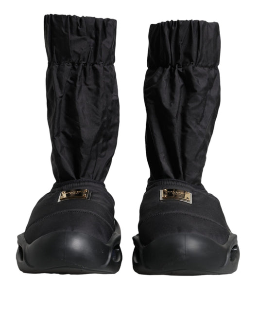 Pair of black boots with gold buckles and straps
