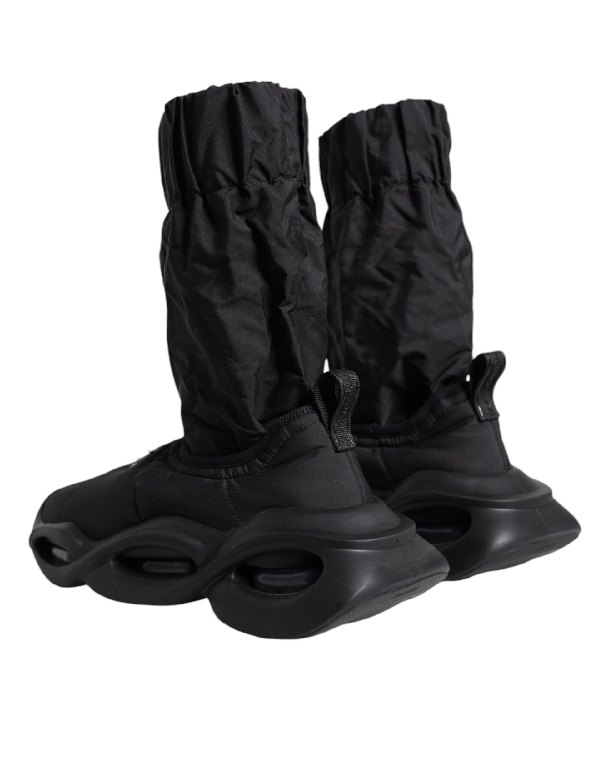 Pair of black rollerblades with black protective boot covers