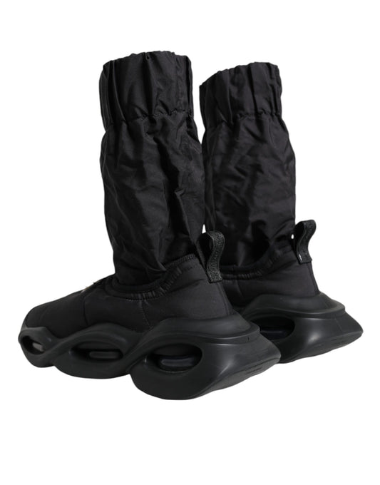 Pair of black rollerblades with black protective boot covers
