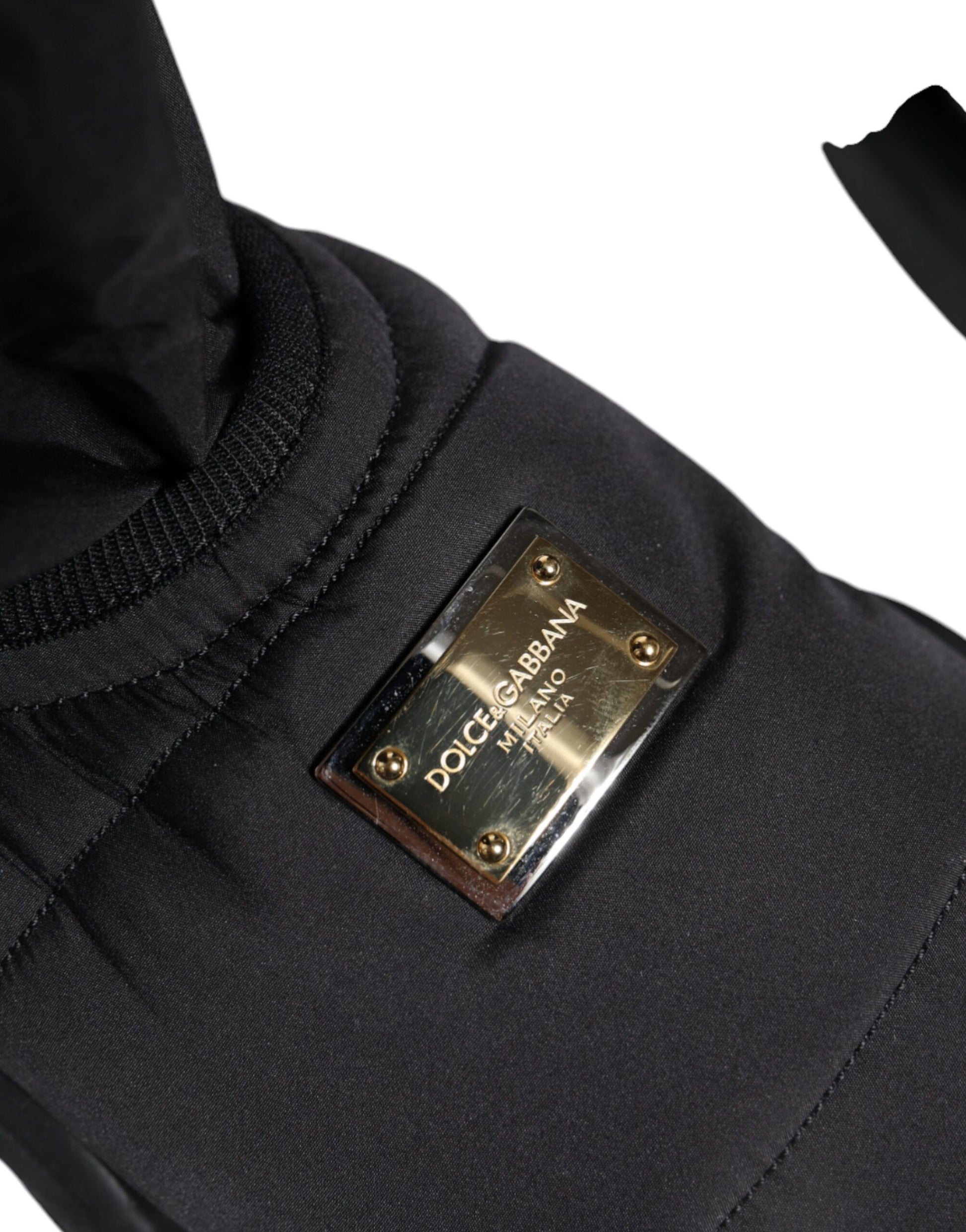 Black jacket with a gold buckle on the sleeve