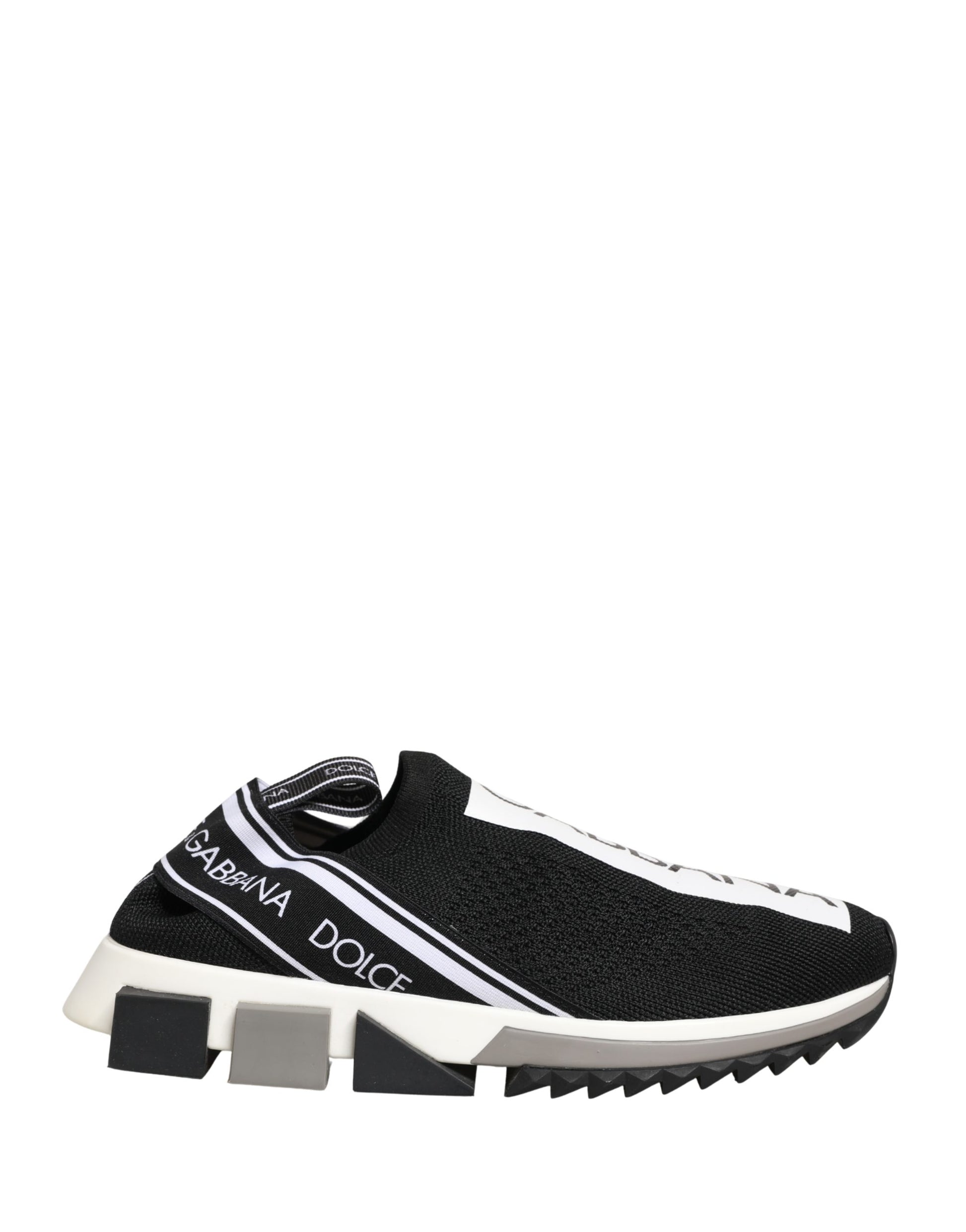 A pair of black slip-on shoes with white soles and a logo on the side