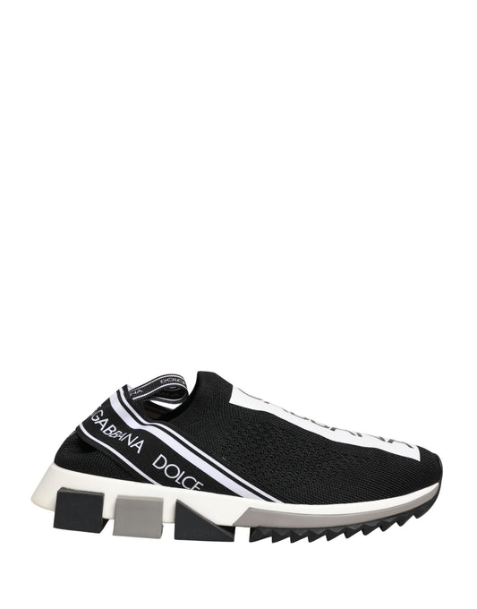 A pair of black slip-on shoes with white soles and a logo on the side
