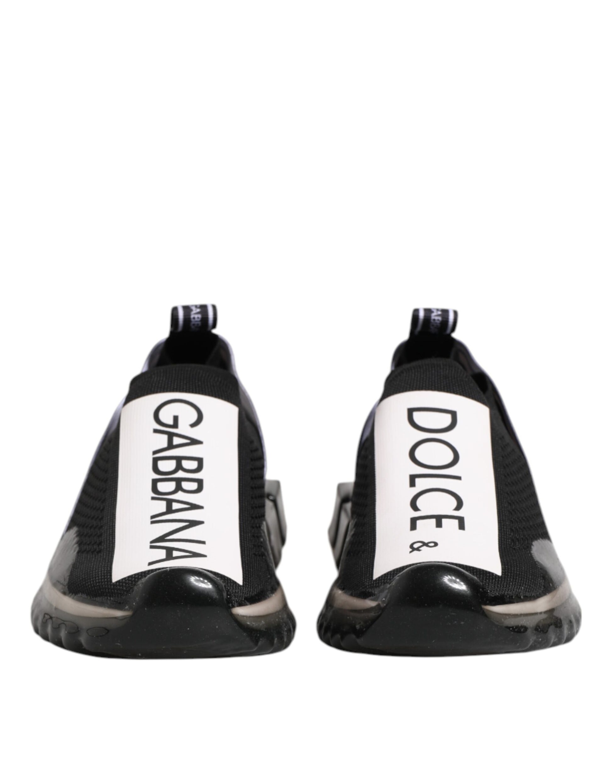 Pair of black slip-on shoes with white text reading "Dolce & Gabbana" and "Sorrento"