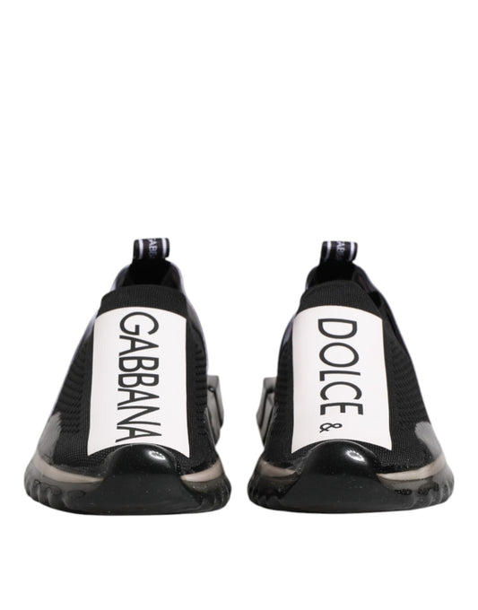 Pair of black slip-on shoes with white text reading "Dolce & Gabbana" and "Sorrento"