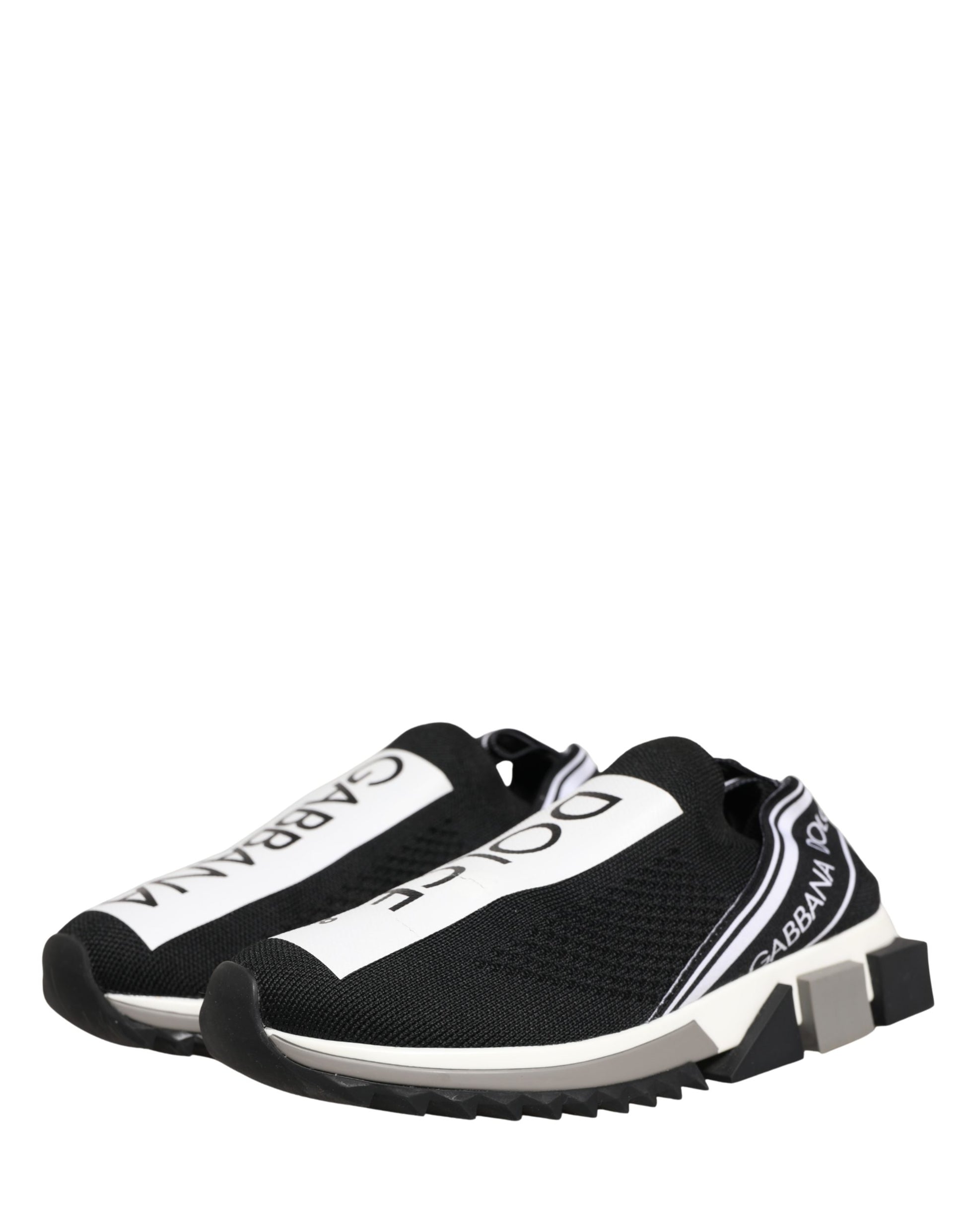 A pair of black and white slip-on shoes with a logo on the side