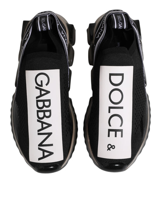 Pair of black slip-on shoes with white text and logos