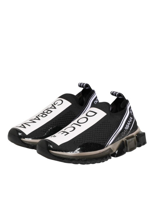 A pair of black and white slip-on shoes with a logo on the side