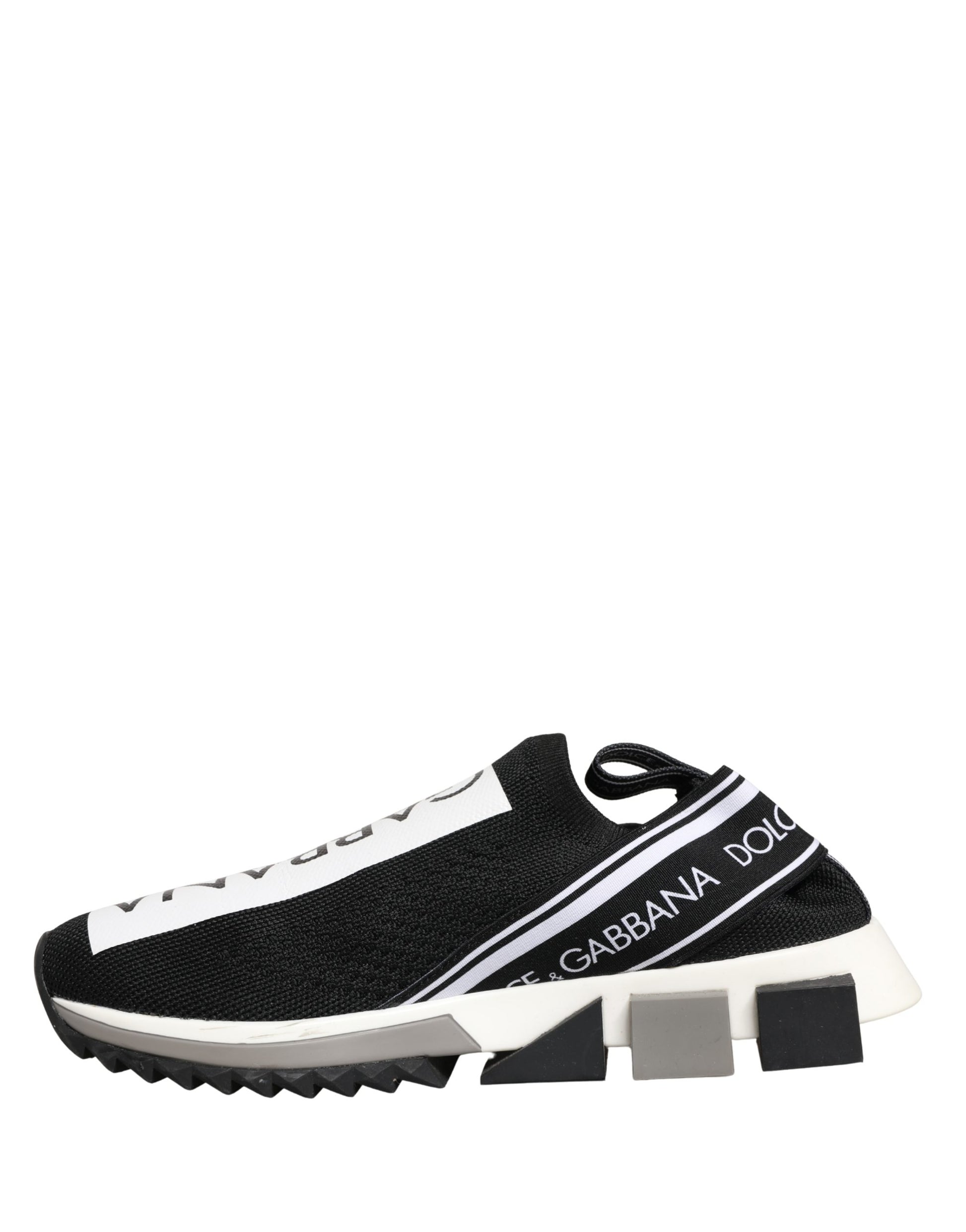 A pair of black slip-on shoes with white soles and a logo on the side