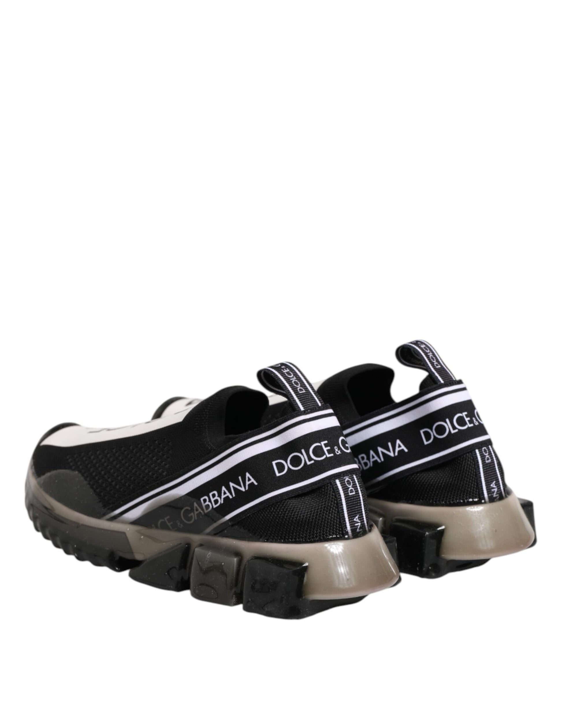 A pair of black slip-on shoes with white branding and a low top